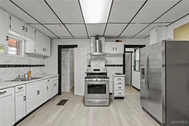 75 Box Ave, Buffalo, NY 14211 - kitchen with stainless steel appliances, a sink, wall chimney range hood, a drop ceiling, and white cabinetry