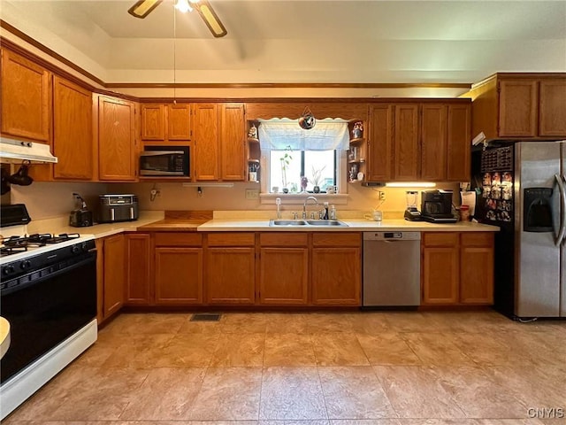 237 James St, Lenox, NY 13032 - kitchen featuring appliances with stainless steel finishes, a sink, brown cabinets, light countertops, and a ceiling fan