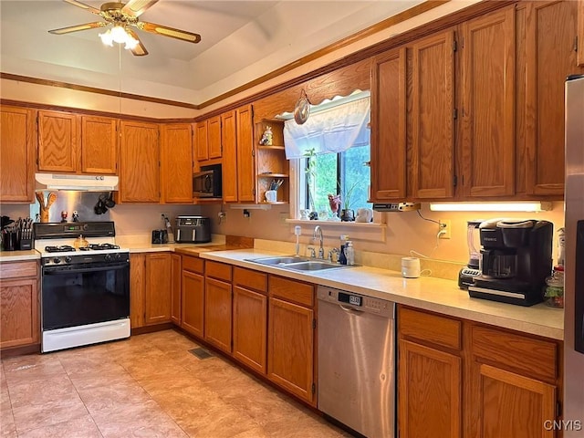 237 James St, Lenox, NY 13032 - kitchen with gas range, dishwasher, a sink, under cabinet range hood, and brown cabinets