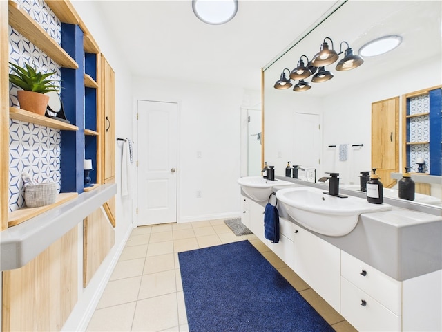 bathroom featuring tile patterned flooring, vanity, and baseboards