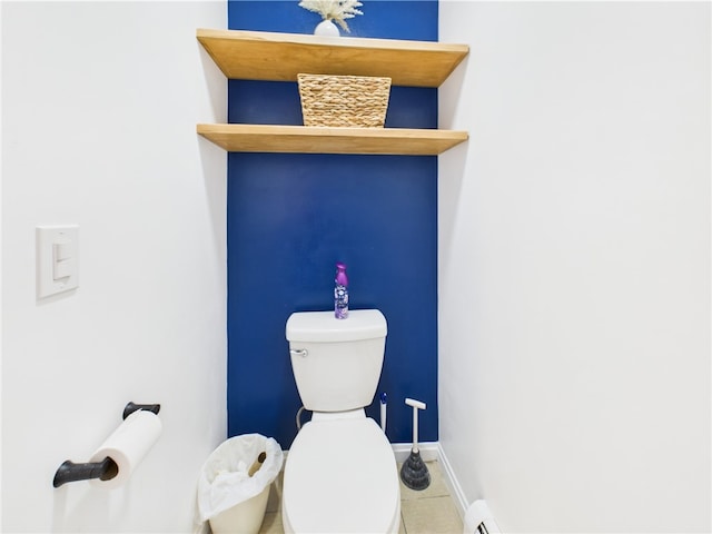 bathroom with tile patterned floors, toilet, and baseboards