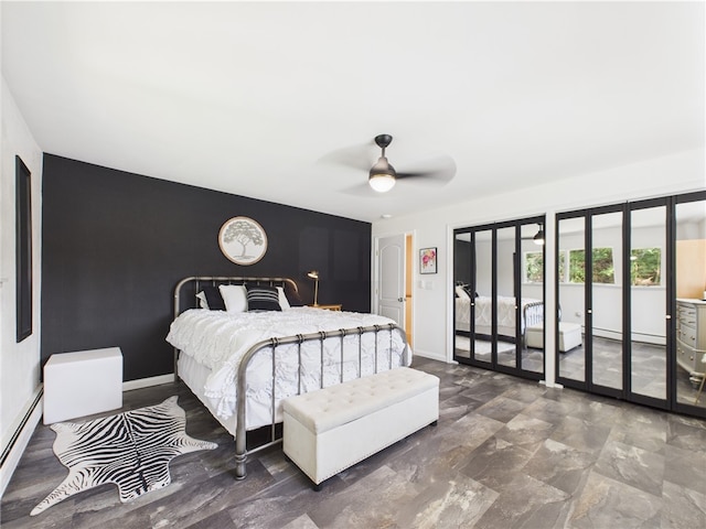 bedroom with an accent wall, a baseboard heating unit, access to exterior, baseboards, and a ceiling fan