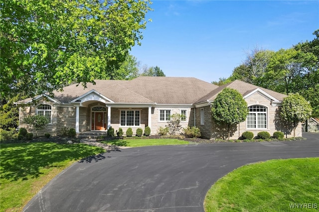 56 Sunset Ln, Orchard Park, NY 14127 - ranch-style house featuring stone siding and a front lawn