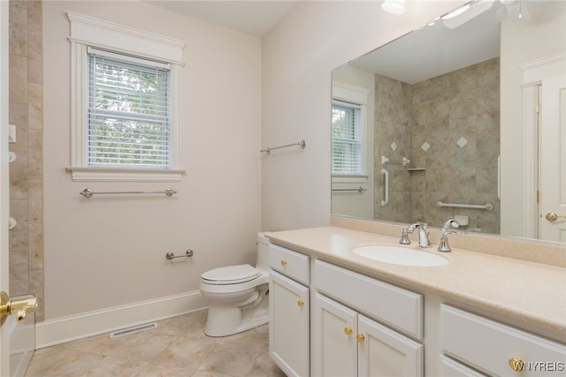 56 Sunset Ln, Orchard Park, NY 14127 - full bathroom featuring a tile shower, tile patterned flooring, toilet, and baseboards