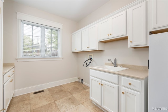 56 Sunset Ln, Orchard Park, NY 14127 - laundry area featuring hookup for a washing machine, baseboards, and cabinet space