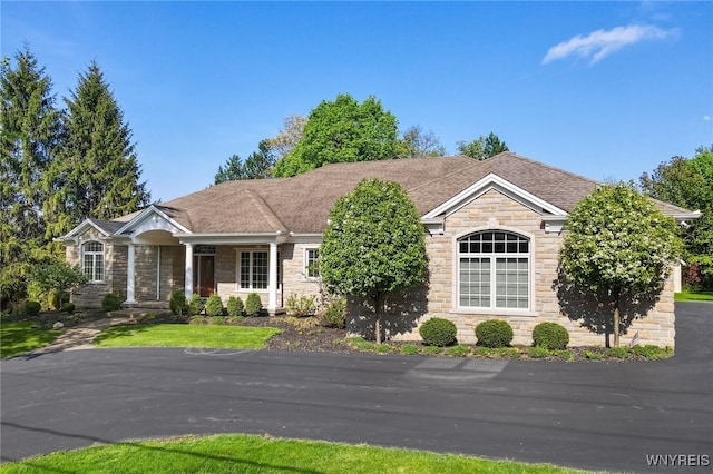 56 Sunset Ln, Orchard Park, NY 14127 - view of front of property with stone siding and a shingled roof