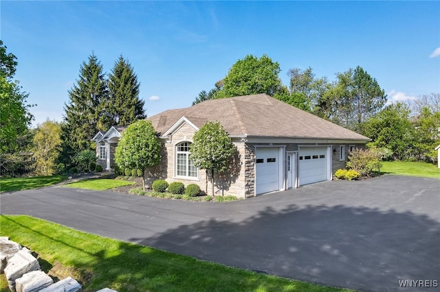 56 Sunset Ln, Orchard Park, NY 14127 - view of property exterior featuring stone siding, asphalt driveway, and an attached garage