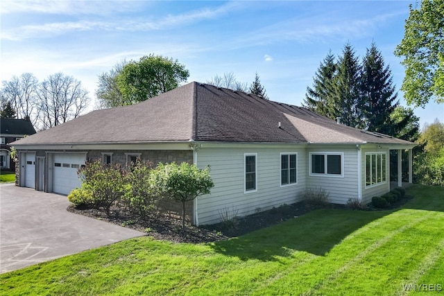 56 Sunset Ln, Orchard Park, NY 14127 - view of side of property with an attached garage, driveway, a yard, and a shingled roof