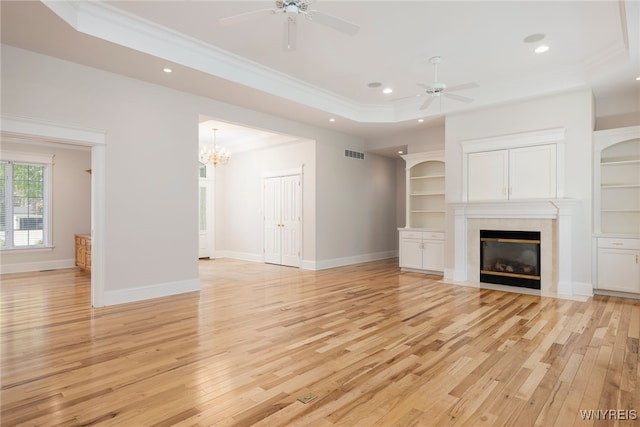 56 Sunset Ln, Orchard Park, NY 14127 - unfurnished living room with a raised ceiling, crown molding, light wood finished floors, recessed lighting, and ceiling fan