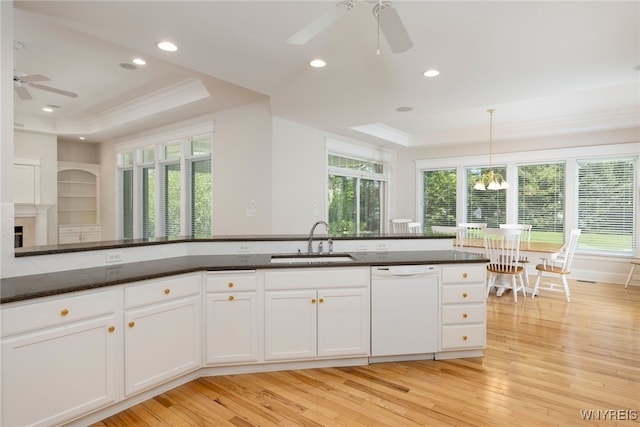 56 Sunset Ln, Orchard Park, NY 14127 - kitchen with a raised ceiling, a ceiling fan, a sink, dishwasher, and crown molding