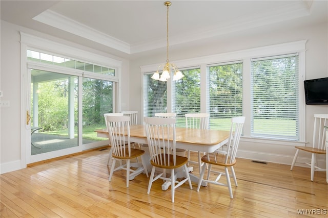 56 Sunset Ln, Orchard Park, NY 14127 - dining space featuring a tray ceiling, ornamental molding, a chandelier, baseboards, and plenty of natural light