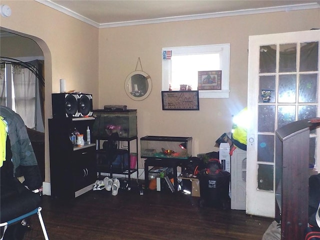 office space featuring wood finished floors, crown molding, and arched walkways