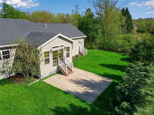 1275 Center St, Aurora, NY 14052 - back of house featuring a patio area, entry steps, a yard, and roof with shingles