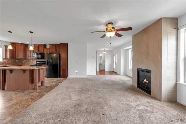 1275 Center St, Aurora, NY 14052 - unfurnished living room with a ceiling fan, light colored carpet, a fireplace, and baseboards