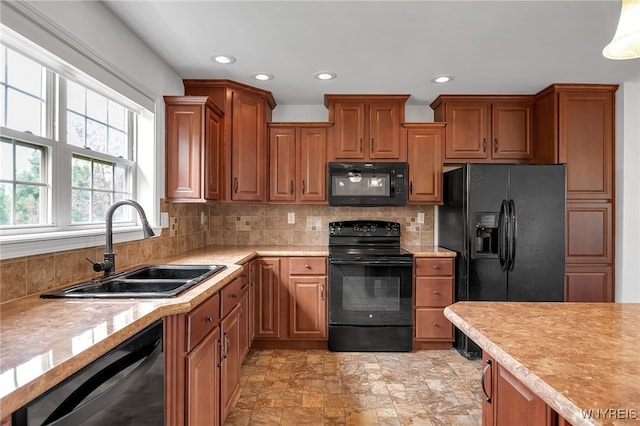 1275 Center St, Aurora, NY 14052 - kitchen with black appliances, a sink, light countertops, brown cabinetry, and recessed lighting