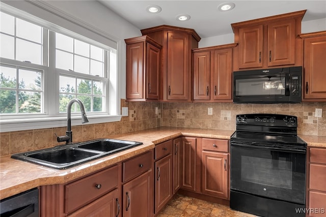 1275 Center St, Aurora, NY 14052 - kitchen featuring black appliances, a sink, light countertops, recessed lighting, and tasteful backsplash