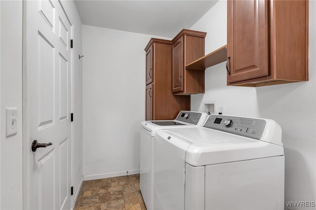 1275 Center St, Aurora, NY 14052 - laundry room with washer and dryer, cabinet space, baseboards, and stone finish flooring