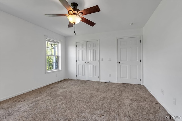 1275 Center St, Aurora, NY 14052 - unfurnished bedroom featuring carpet flooring, baseboards, a closet, and ceiling fan