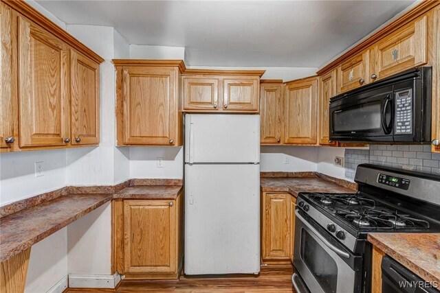 kitchen with black appliances and wood finished floors