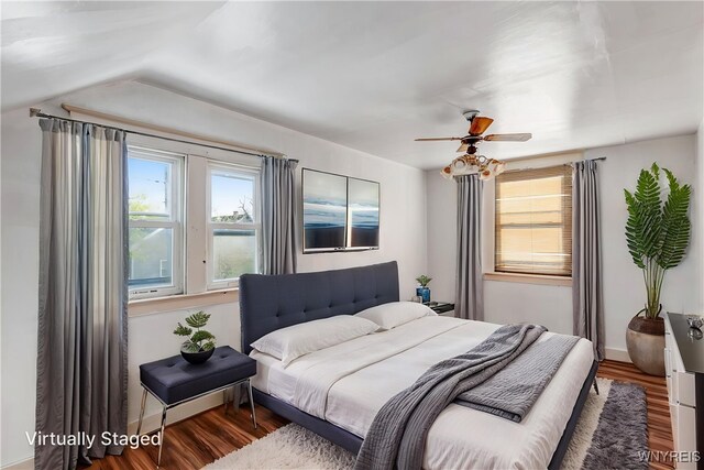 bedroom featuring wood finished floors, baseboards, and ceiling fan