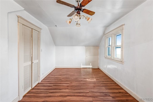 bonus room with wood finished floors, lofted ceiling, baseboards, and a ceiling fan