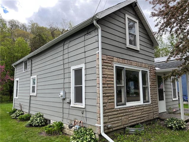 332 Jamestown St, Persia, NY 14070 - view of side of property with stone siding and a lawn