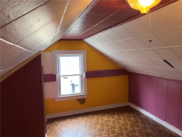 332 Jamestown St, Persia, NY 14070 - additional living space featuring vaulted ceiling, baseboards, and wood walls