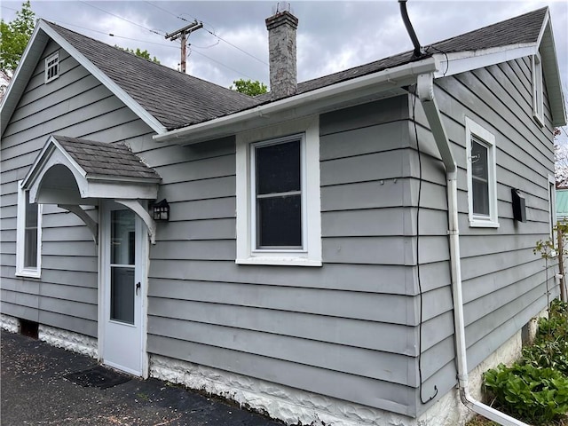 332 Jamestown St, Persia, NY 14070 - view of side of property with roof with shingles and a chimney