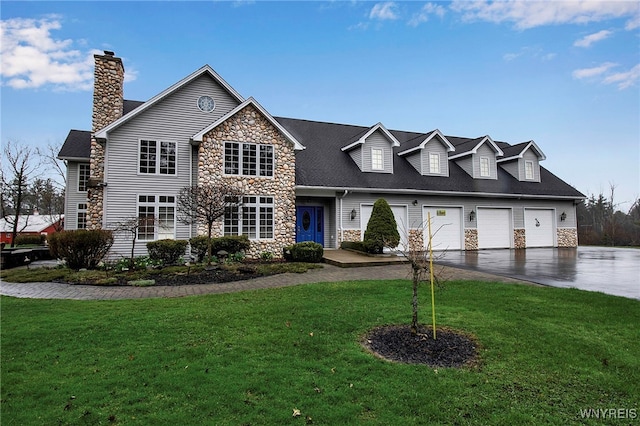 100 May Dr, Elma, NY 14059 - view of front facade with stone siding, driveway, a front lawn, and a chimney