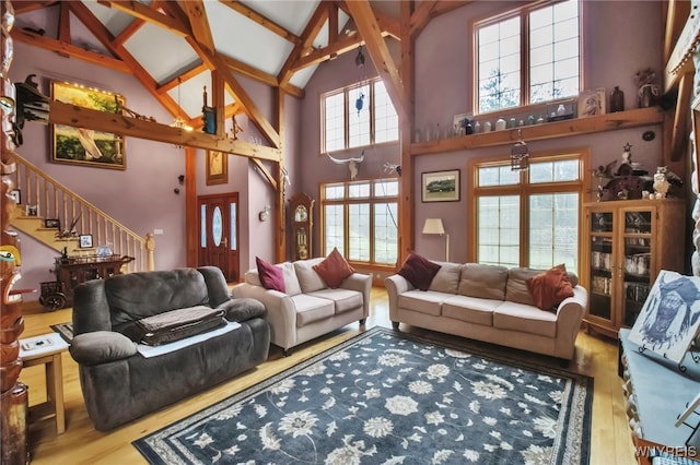 100 May Dr, Elma, NY 14059 - living area featuring wood finished floors, high vaulted ceiling, stairs, and beamed ceiling