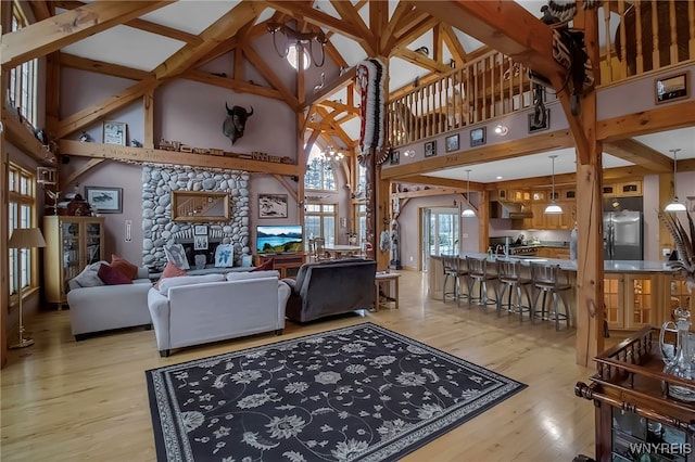 100 May Dr, Elma, NY 14059 - living room with high vaulted ceiling, wood finished floors, and a stone fireplace