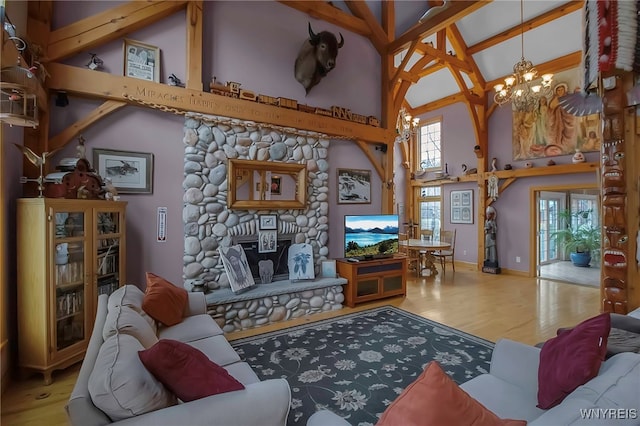 100 May Dr, Elma, NY 14059 - living area featuring high vaulted ceiling, a chandelier, wood finished floors, healthy amount of natural light, and beam ceiling
