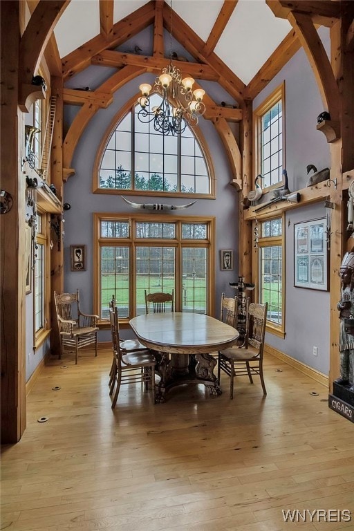 100 May Dr, Elma, NY 14059 - dining area with high vaulted ceiling, a chandelier, beam ceiling, plenty of natural light, and light wood-style floors