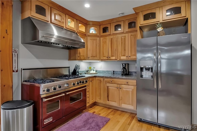 100 May Dr, Elma, NY 14059 - kitchen with stainless steel appliances, under cabinet range hood, light wood finished floors, light stone countertops, and glass insert cabinets