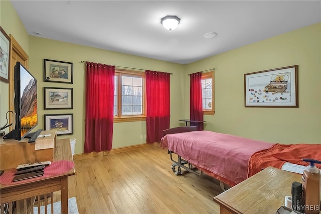 100 May Dr, Elma, NY 14059 - bedroom featuring wood-type flooring, multiple windows, and baseboards