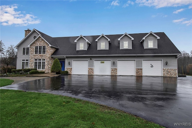 100 May Dr, Elma, NY 14059 - view of front of property featuring stone siding, asphalt driveway, a chimney, and roof with shingles