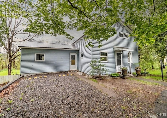 back of property featuring metal roof