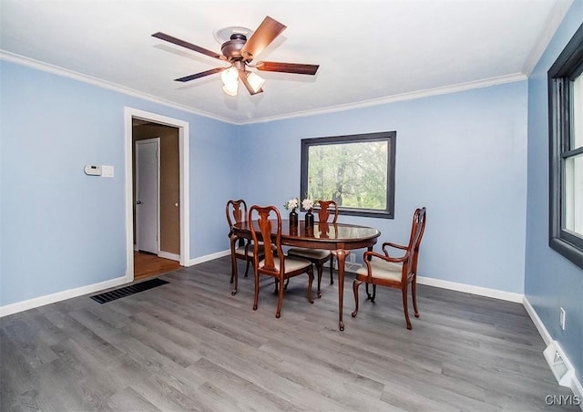 dining area with baseboards, ceiling fan, wood finished floors, and ornamental molding