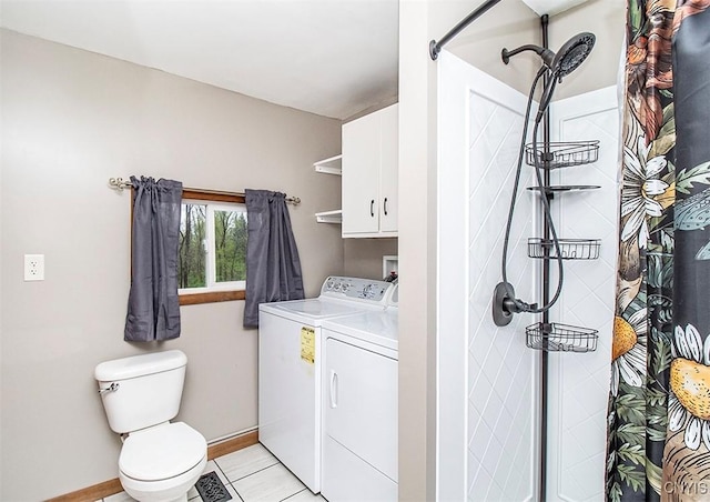 bathroom featuring washing machine and clothes dryer, a stall shower, baseboards, toilet, and tile patterned flooring