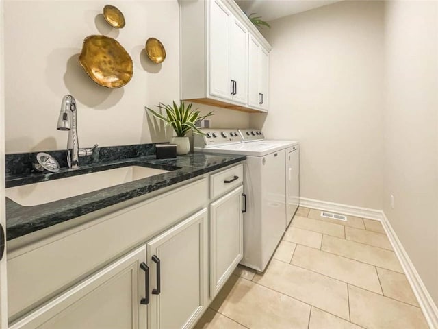 1549 Osburn Ln, Farmington, NY 14425 - laundry area with cabinet space, washer and clothes dryer, baseboards, and light tile patterned flooring