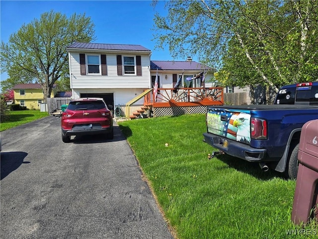 6943 Academy Ln, Lockport-Town, NY 14094 - split level home with driveway, a wooden deck, a garage, and metal roof