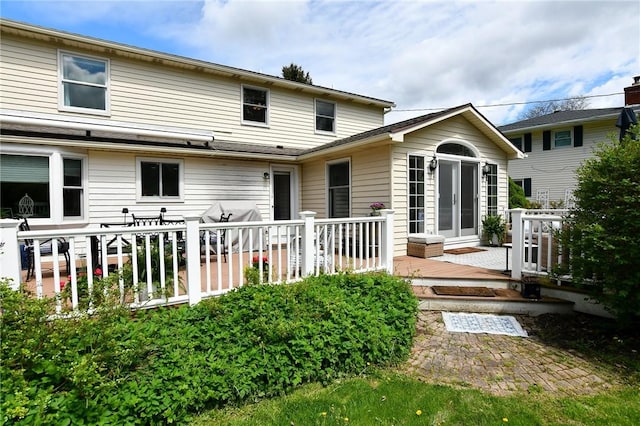 rear view of house with a wooden deck