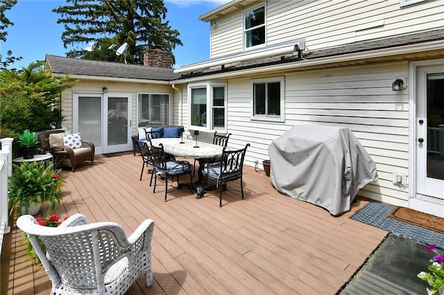 wooden deck with outdoor dining space