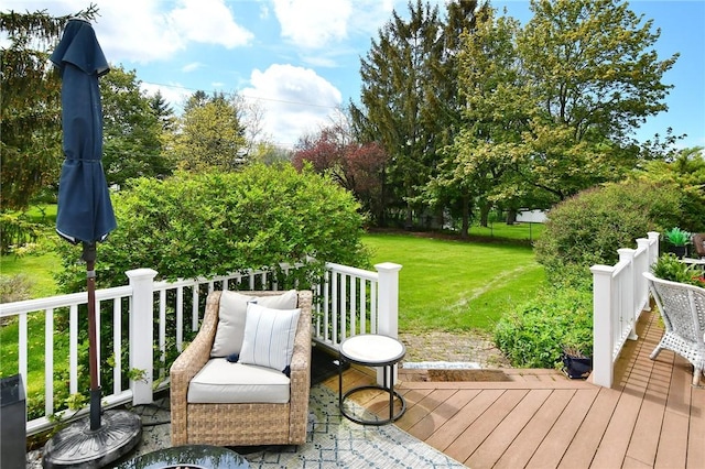 wooden terrace featuring a lawn