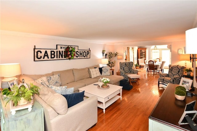 living room featuring wood finished floors and crown molding