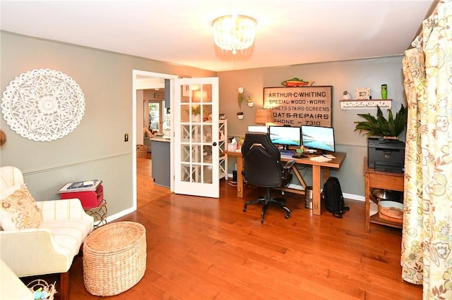 office space with french doors, wood finished floors, a chandelier, and baseboards