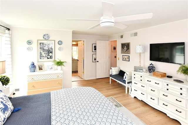 bedroom with light wood-style floors, crown molding, connected bathroom, and ceiling fan