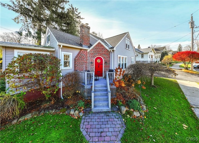 view of front facade with a front yard and a chimney