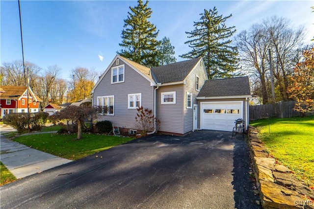 view of property exterior with asphalt driveway, an attached garage, and a shingled roof