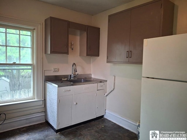 11 Prather Ave, Jamestown, NY 14701 - kitchen with freestanding refrigerator, a sink, baseboards, and dark countertops